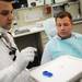 Dr. Chady A. Elhage speaks with patient Jean-Claude Soloman, 24, as they get started with his appointment on Thursday afternoon at the Graduate Prosthedontics clinic at the U-M Dental School.  Melanie Maxwell I AnnArbor.com